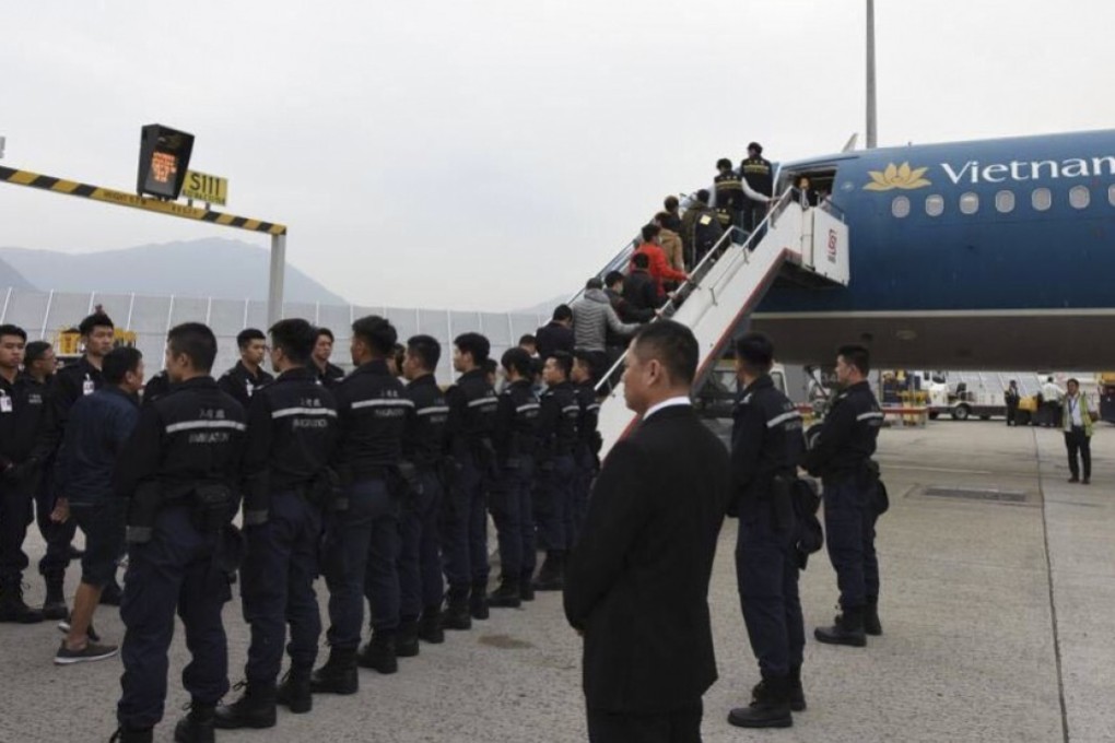A flight chartered by Hong Kong immigration authorities to send 68 unsuccessful asylum seekers back to Vietnam boards on December 29, 2017. Photo: Handout
