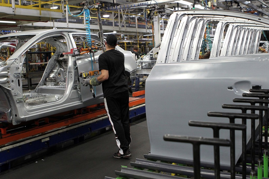 A worker installing doors on the new Chevrolet Cruze on the assembly line at General Motors’ assembly in Lordstown, Ohio on July 22, 2011. Photo: Reuters