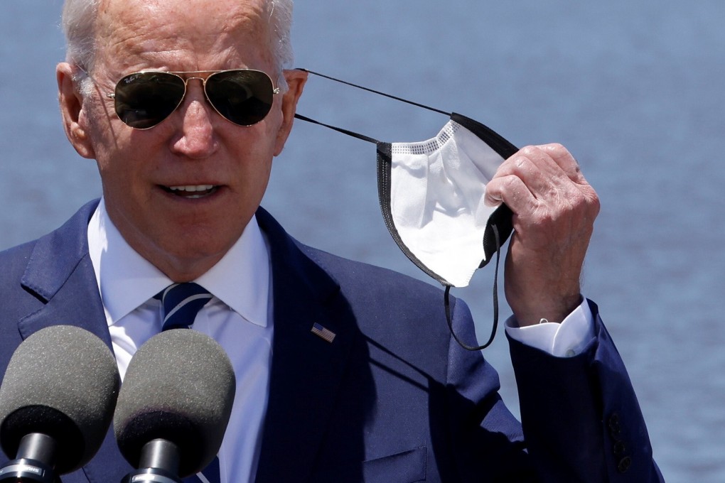US President Joe Biden removes his face mask before speaking in Lake Charles, Louisiana, on May 6. Photo: Reuters