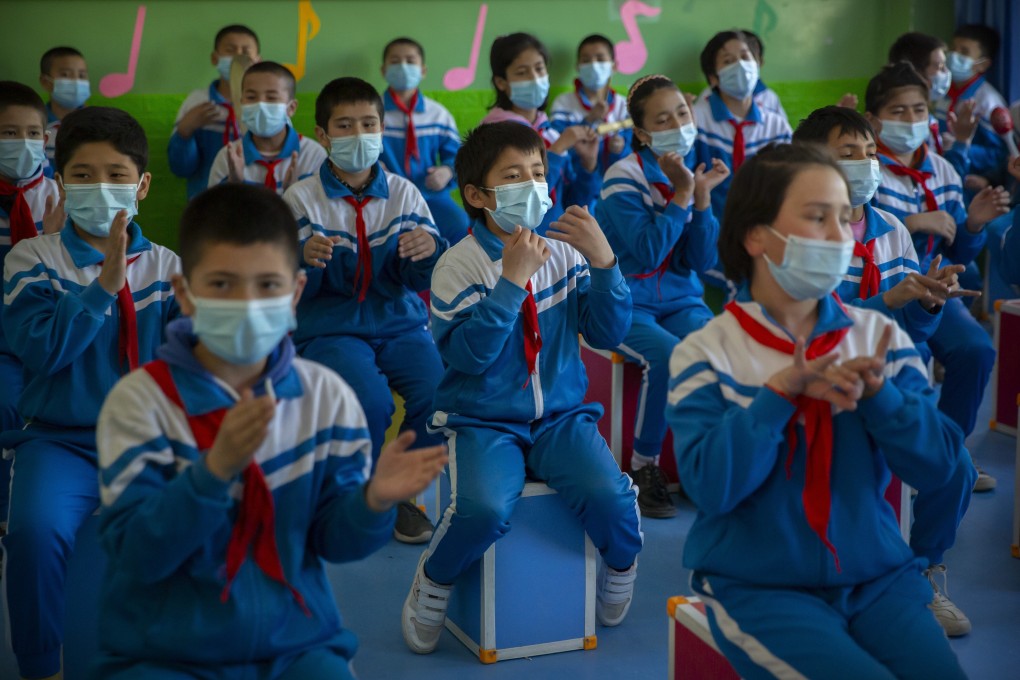 Schoolchildren in Kashgar, Xinjiang, take part in a music class during a government-organised visit for foreign journalists. It is claimed that indigenous birth rates in the region have plummeted. Photo: AP