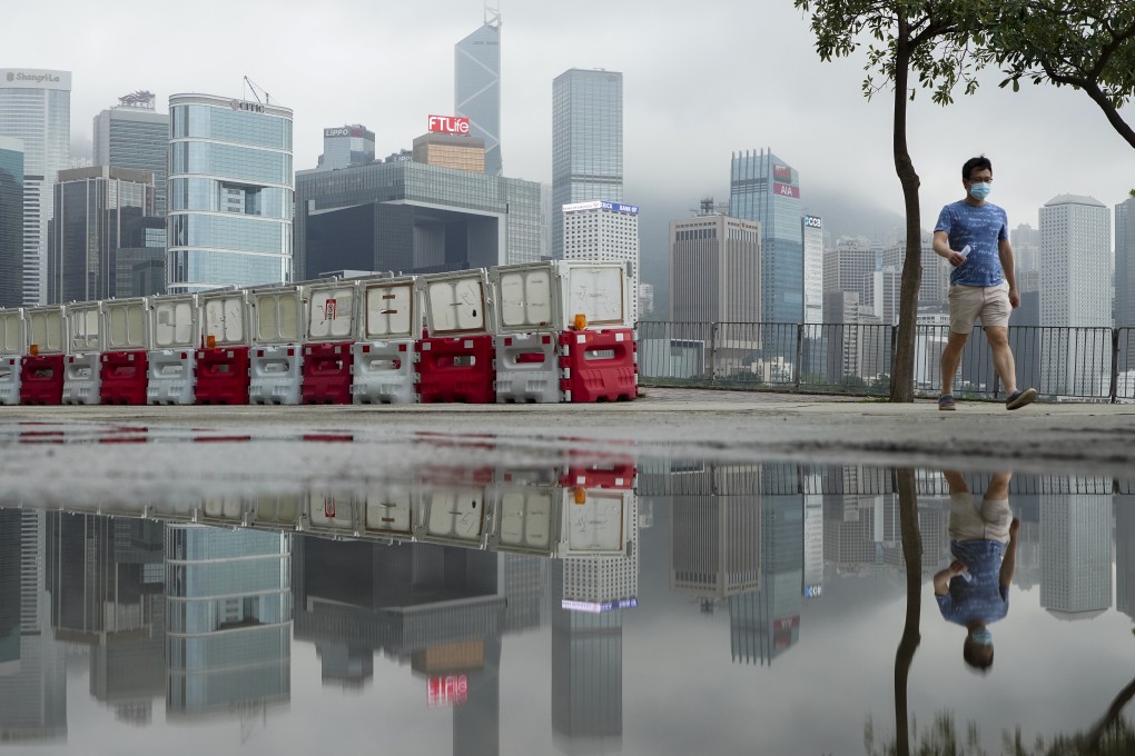 A man walks in Wan Chai. Neither the economy nor life can get back to normal without a successful vaccination campaign. Photo: Robert Ng