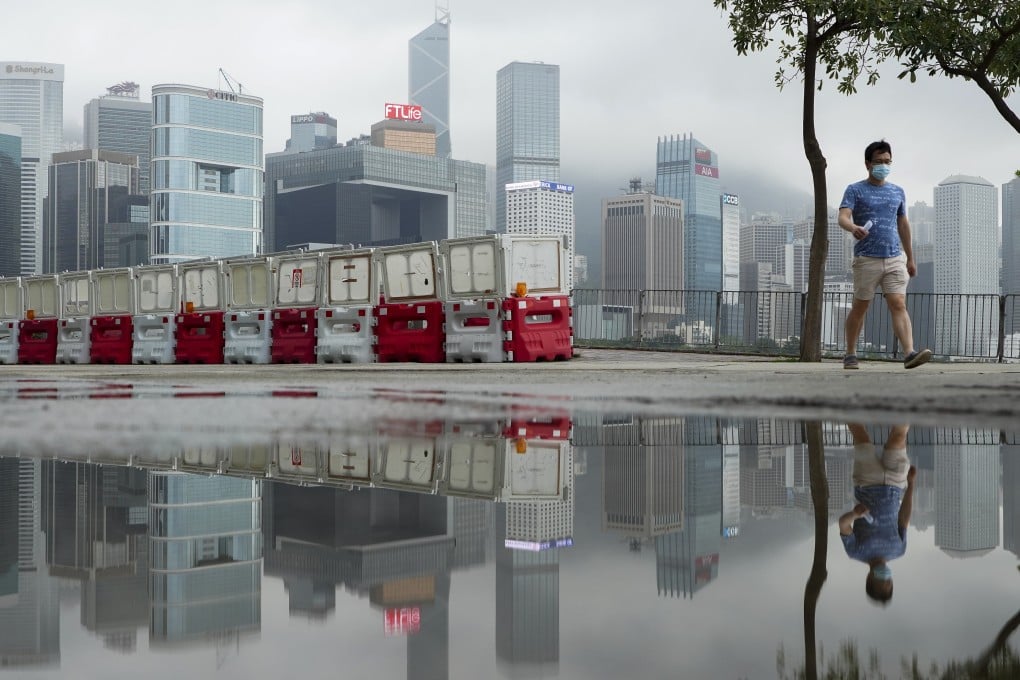 A man walks in Wan Chai. Neither the economy nor life can get back to normal without a successful vaccination campaign. Photo: Robert Ng