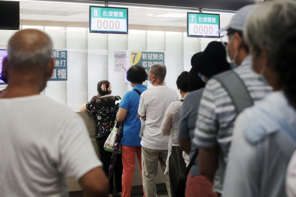 People wait in line at a Covid-19 vaccination centre in New Taipei City on Thursday. A rising number of locally transmitted cases is prompting more people to get the jab. Photo: Bloomberg