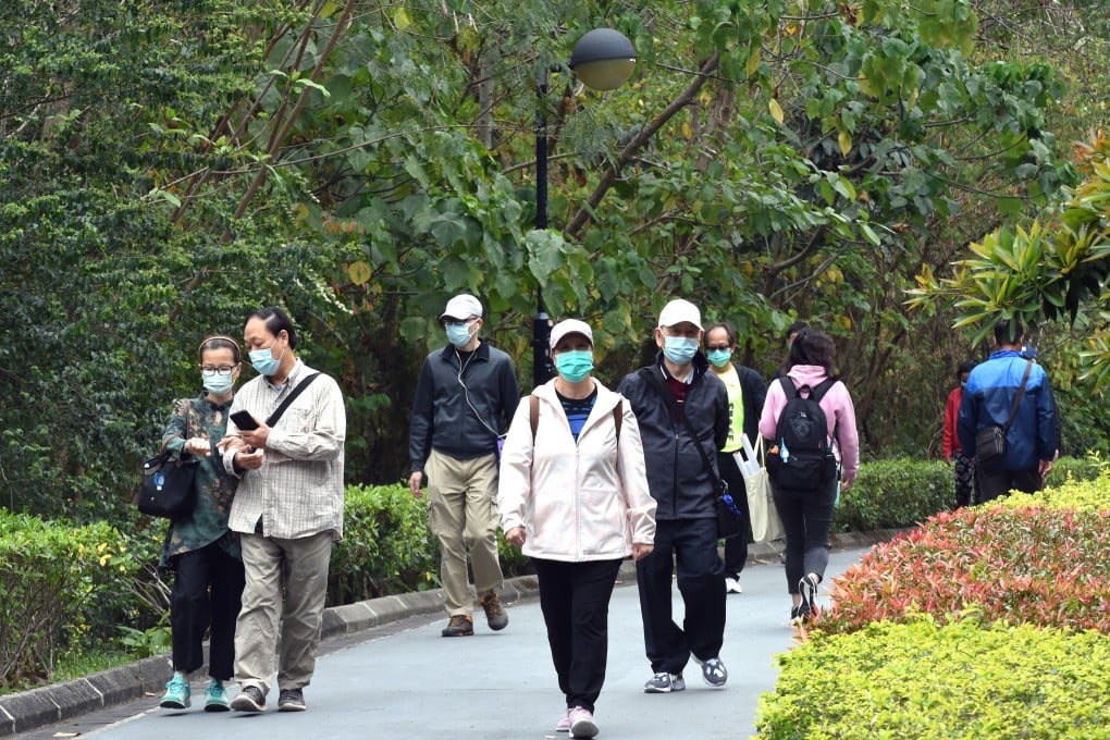 People wearing face masks walk on a street in Hong Kong. Photo: Xinhua