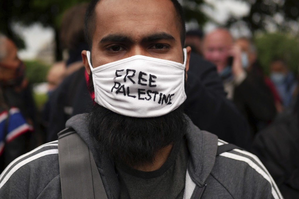 A protester wears a face mask reading “Free Palestine” during a protest in solidarity with Palestinians in Paris on Wednesday. Photo: AP