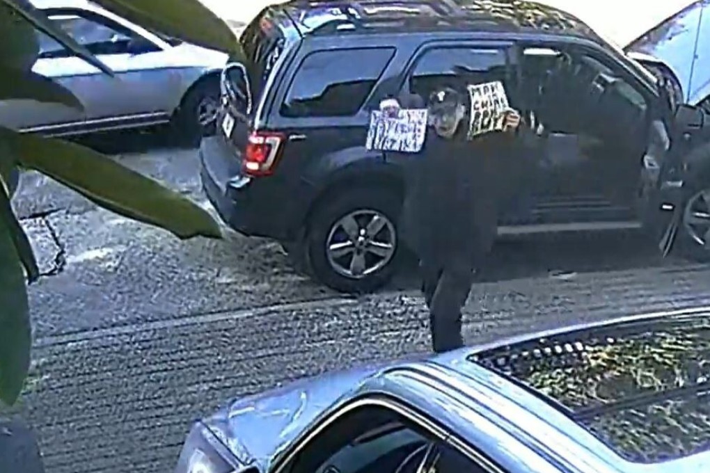 A man blocks the car of an employee of the Chinese consulate in Vancouver, British Columbia, on March 22. The suspect then spit on the employee’s car and berated him, police said. Photo: VPD
