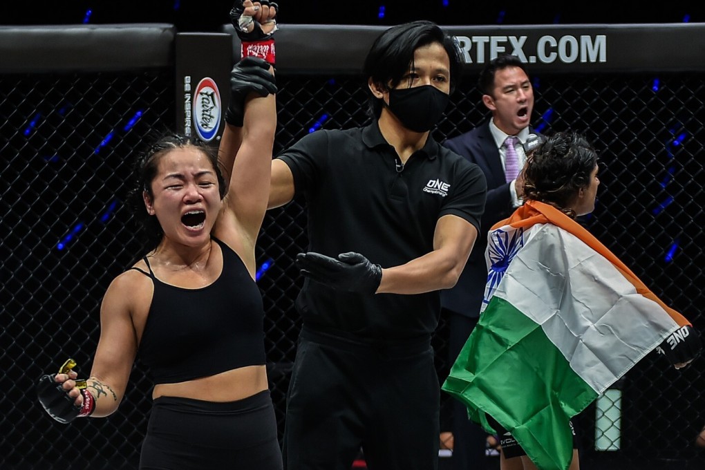 Bi Nguyen'’s arm is raised as Ritu Phogat turns away in shock. Photos: ONE Championship