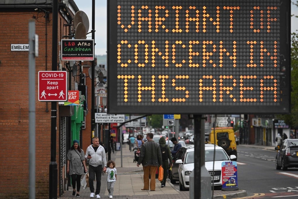 A public health digital board warns the public of a Covid-19 variant of concern affecting the community in Bolton, England on Friday. Photo: AFP