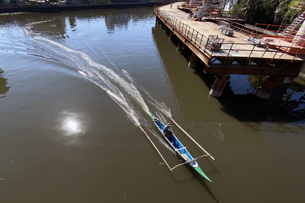 A fisherman on a banca, a native boat in the Philippines, manoeuvres next to a railroad construction project in Paranaque city, south of Manila, on May 3. Asia has an annual infrastructure investment gap of US$900 billion. Photo: EPA-EFE