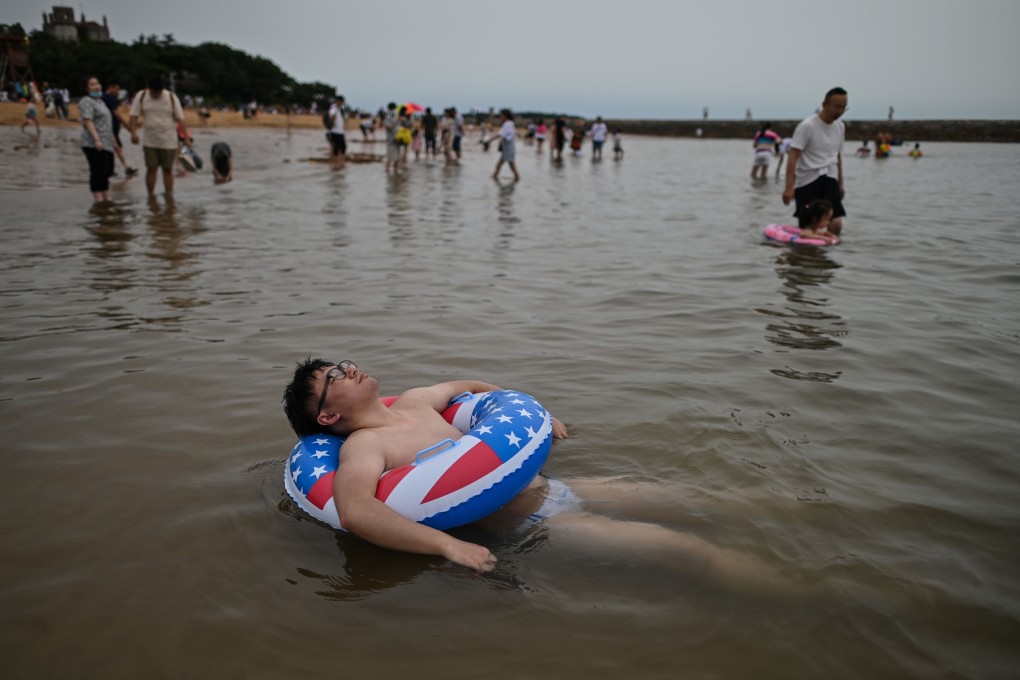 A man floats in the water at a beach in Qingdao in east China’s Shandong province in July 2020. Photo: AFP