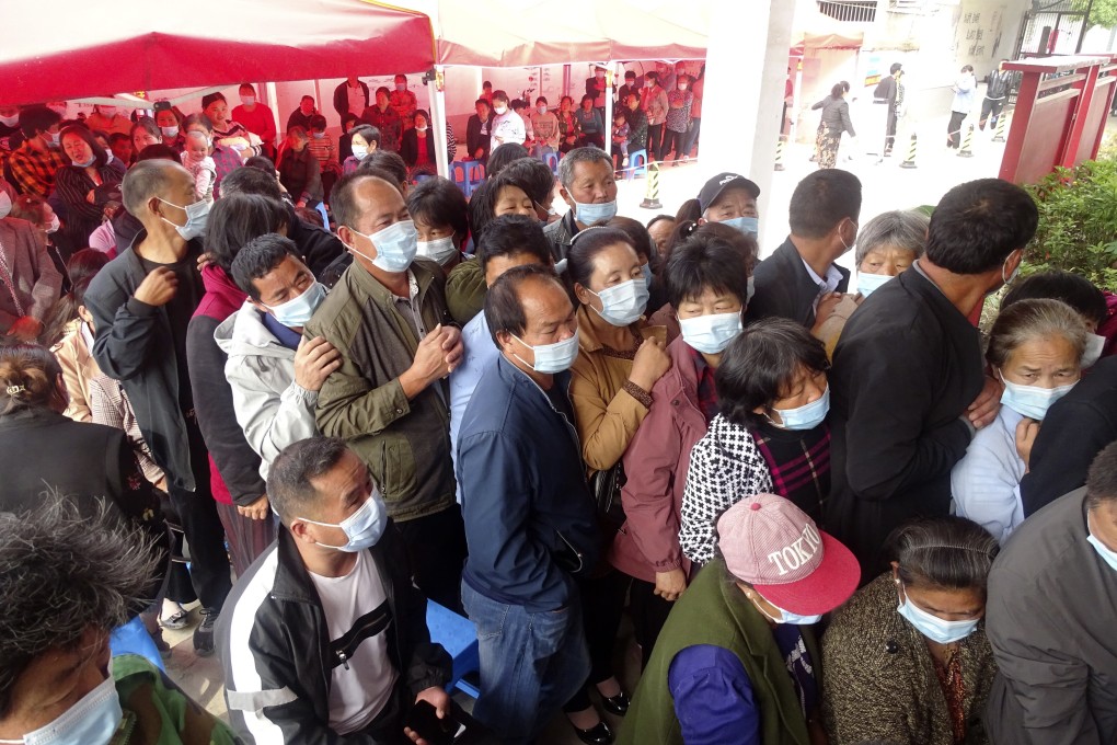 People line up for Covid-19 vaccinations at a rural mass vaccination site in Linquan county in eastern China’s Anhui province on Thursday. Photo: Chinatopix via AP