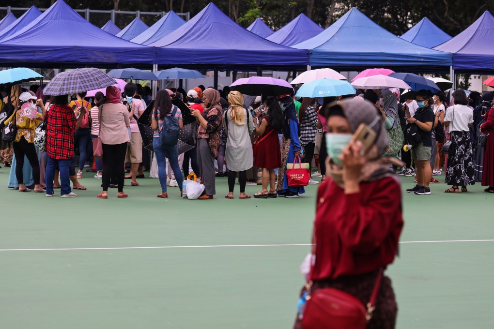 Domestic helpers queue up for a compulsory Covid-19 testing at Victoria Park, Causeway Bay. Photo: Nora Tam