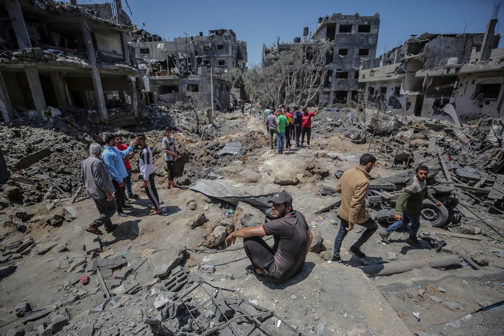 Palestinians examine the remains of houses after Israeli air strikes in Beit Hanun in the northern Gaza Strip on Friday. Photo: EPA-EFE
