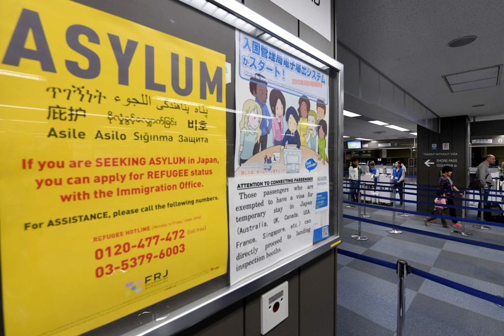 A poster about seeking asylum is seen near passport control in Tokyo’s Narita International Airport. The Japanese government’s withdrawn proposals would have fast-tracked deportations for foreigners, including asylum seekers. Photo: AFP