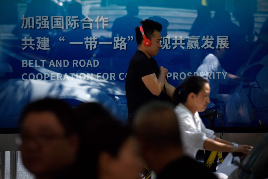 A man wearing headphones walking past a bus station on May 10, 2017. Photo: AFP