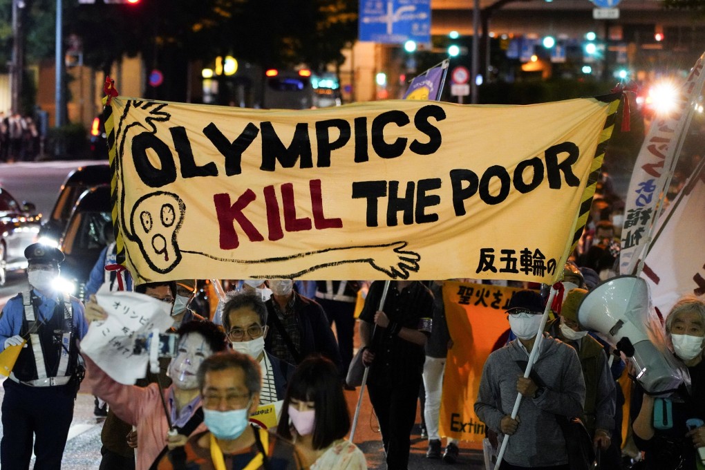 Protesters carry banners at a night march in Tokyo. Photo: Reuters