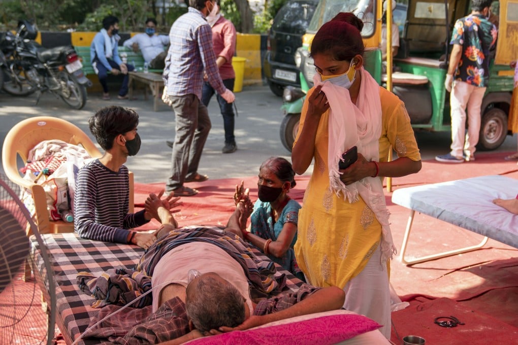 Relatives attend to a Covid-19 patient at the Shri Guru Singh Sabha Gurdwara in Ghaziabad, Uttar Pradesh, in India on May 11. Photo: Bloomberg
