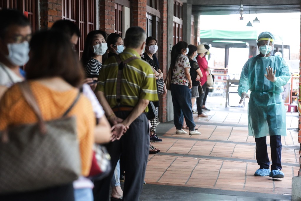 People wait in line at a temporary Covid-19 rapid testing centre in Taipei on Saturday as coronavirus transmissions rise in the community. Photo: Bloomberg