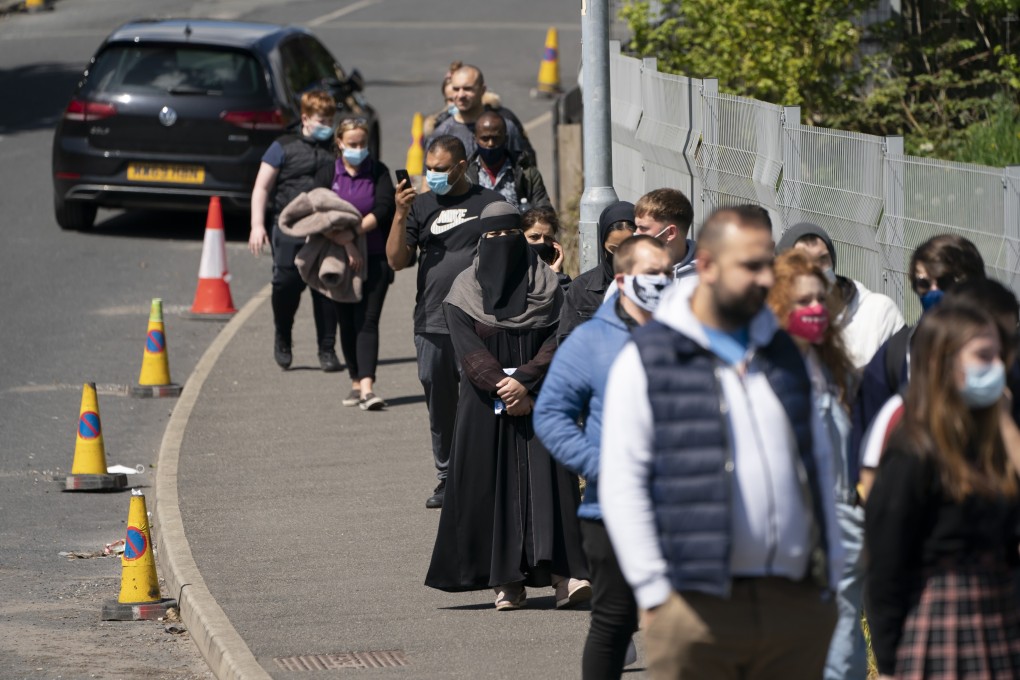 People queue to receive Covid-19 vaccinations in Bolton, England. Photo: AP