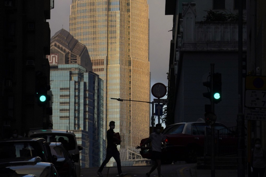 A man walks in front of the IFC tower in Central, Hong Kong, on May 15. Hong Kong is uniquely suited to accommodate the transformation to a new era of finance. Photo: AP
