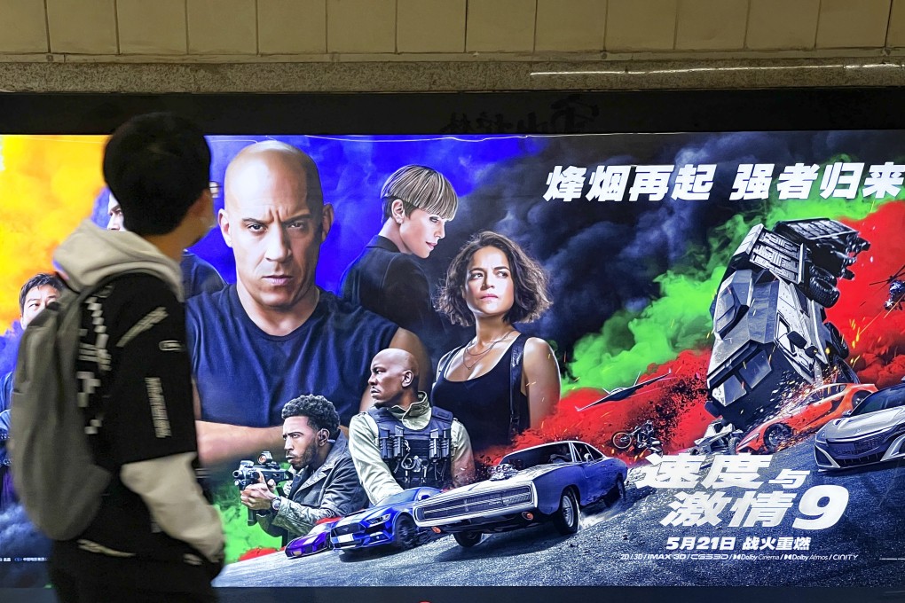 A pedestrian passes a poster for Fast & Furious 9, which opens in mainland China on Friday. Photo: VCG via Getty Images