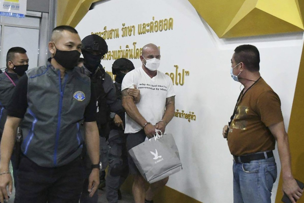 American Louis William Ziskin (centre) is escorted by police in Bangkok, Thailand. Photo: AP