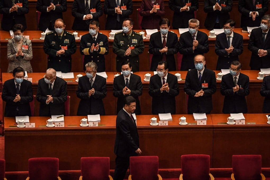Delegates applaud as China's President Xi Jinping arrives for the opening session of the National People's Congress (NPC) at the Great Hall of the People in Beijing on March 5, 2021. Photo: AFP