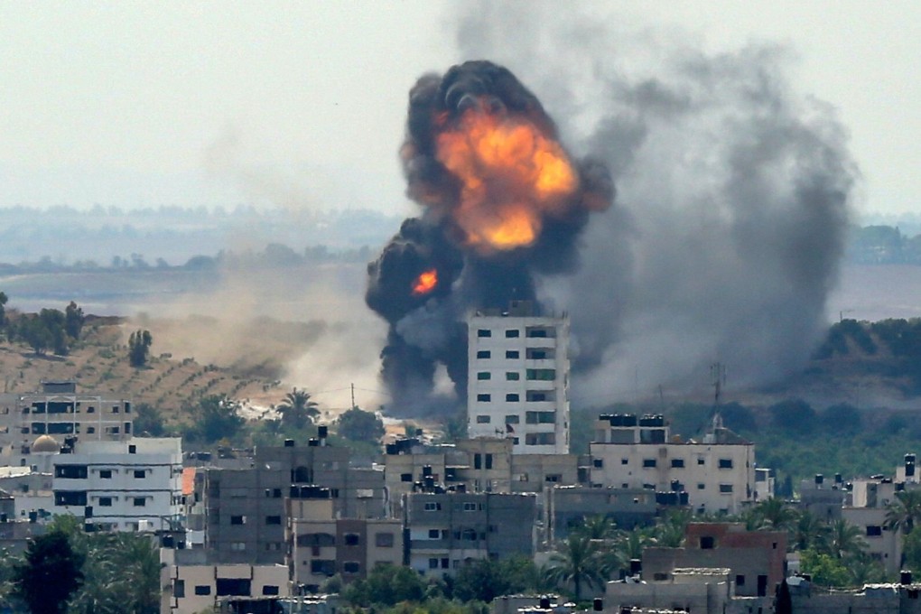 A ball of fire erupts from a building in Gaza City’s Rimal residential district on Thursday. Photo: AFP