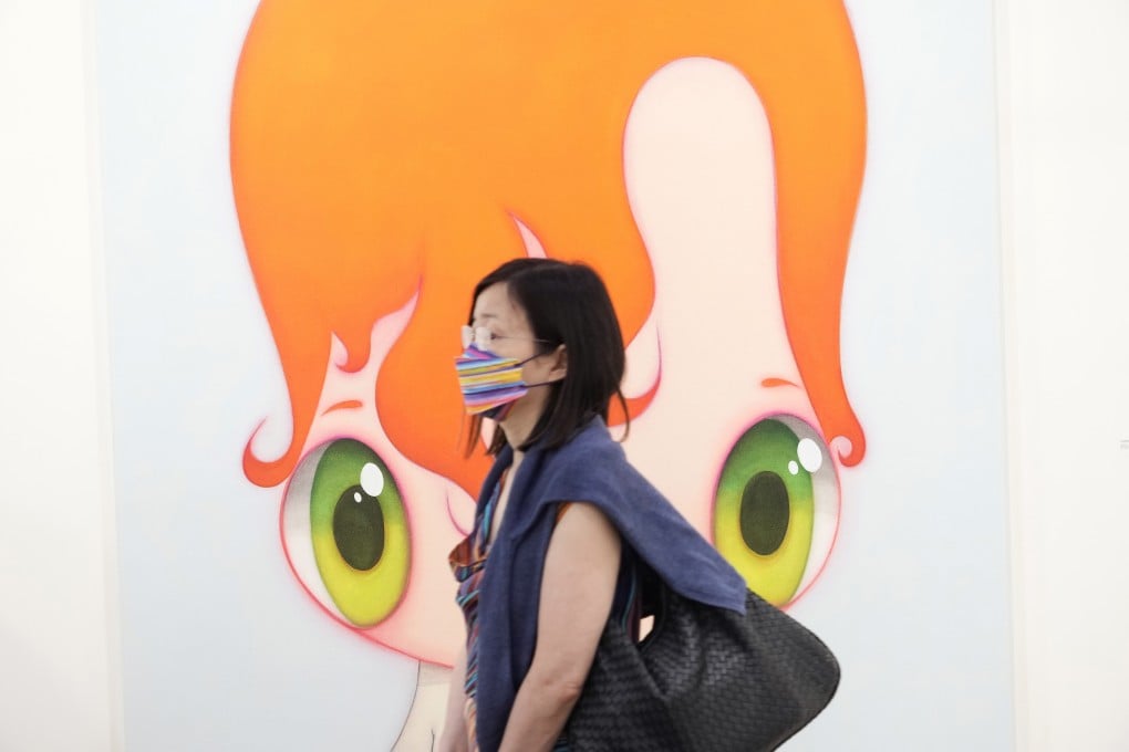A masked visitor walks past an artwork on display at Art Basel in Hong Kong on Wednesday. Photo: AP