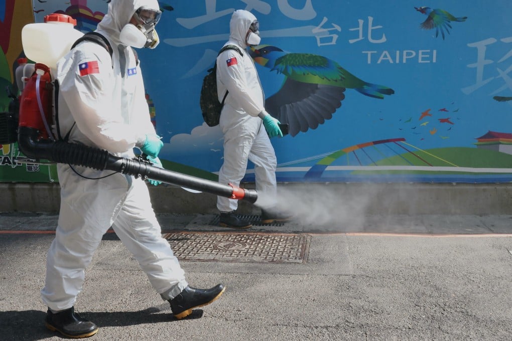 Soldiers disinfect the streets of Taipei’s Wanhua district, which is home to scores of hostess teahouses. Photo: Reuters