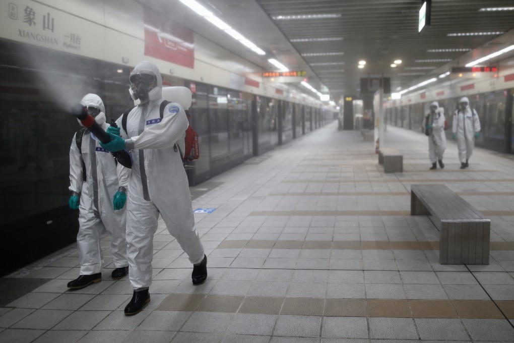 Military personnel spray disinfectant inside a railway station, in Taipei, Taiwan, on Thursday. Photo: EPA-EFE