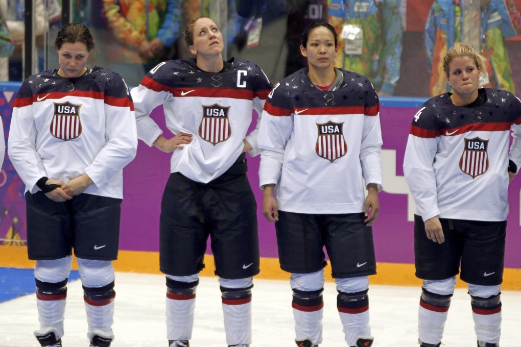 Ice hockey player Julie Chu (second right) with United States team members after missing out on a gold medal against Canada at the Sochi Games in 2014. Photo: Reuters