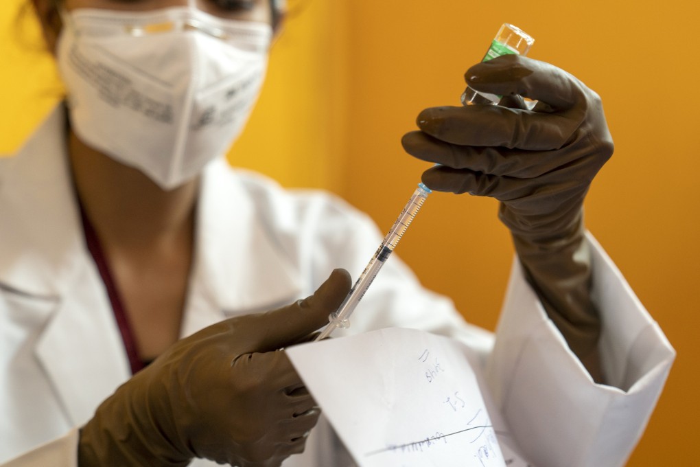 A health worker prepares a dose of Covishield at a vaccination centre in New Delhi on Friday. Photo: Bloomberg