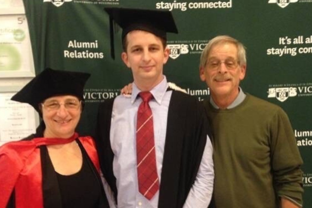 Kelly Savage, centre, pictured with his parents in 2015 at his graduation ceremony. Photo: Hnadout