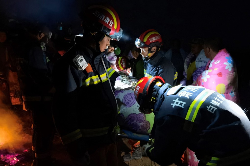Rescuers assist runners who were competing in a 100-kilometre ultramarathon when extreme weather hit the area, leaving 21 dead, in China's northwestern Gansu province. Photo: AFP