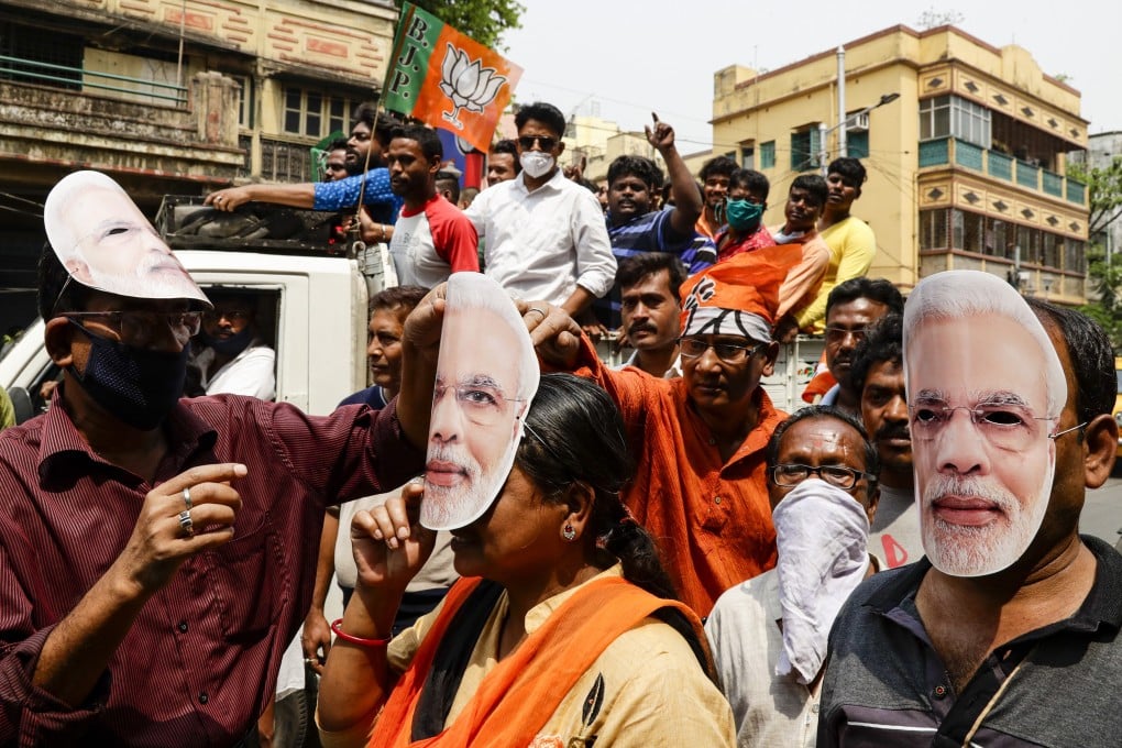 Supporters of India’s ruling Bharatiya Janata Party wear masks bearing the likeness of Prime Minister Narendra Modi during a campaign rally ahead of elections in West Bengal on March 20, despite clear signs of a second wave of coronavirus infections. Photo: AP