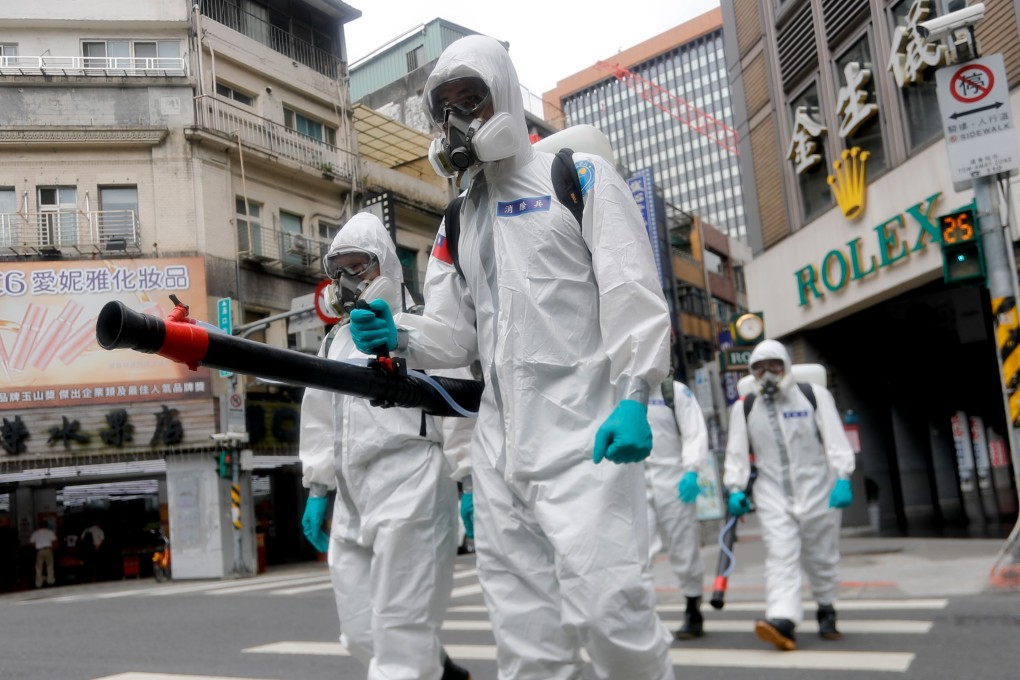 Military officers wearing personal protective equipment disinfect areas in Taipei, as Taiwan has seen a dramatic increase in the number of locally acquired cases. Photo: Zuma Wire/DPA