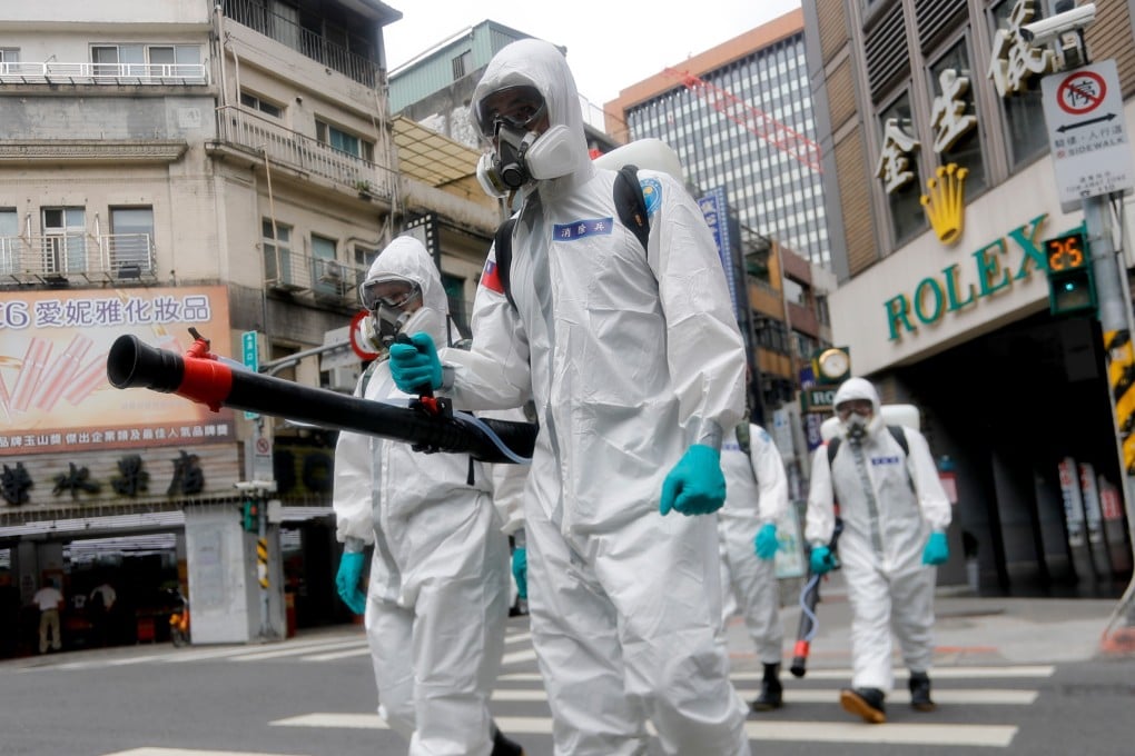Military officers wearing personal protective equipment disinfect areas in Taipei, as Taiwan has seen a dramatic increase in the number of locally acquired cases. Photo: Zuma Wire/DPA