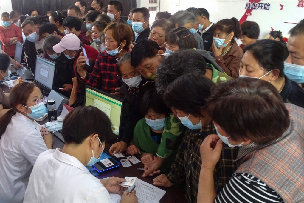 People register information as they prepare to receive the Anhui Zhifei Longcom Covid-19 coronavirus vaccine in Fuyang in eastern Anhui province on May 13. Photo: AFP