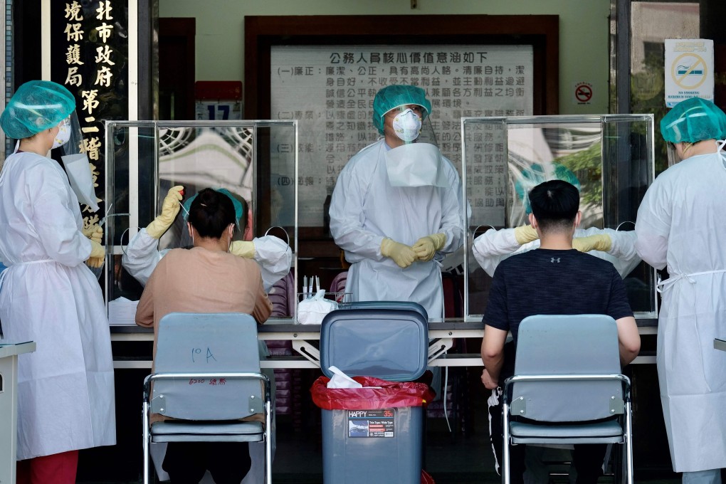 Medical workers collect samples from residents at a coronavirus testing centre in New Taipei City. Photo: AFP