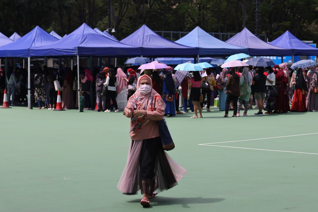 Foreign domestic helpers in Hong Kong queue up in Victoria Park for a second Covid-19 screening ordered by the government, an order denounced by many commentators as discriminatory. Photo: Nora Tam