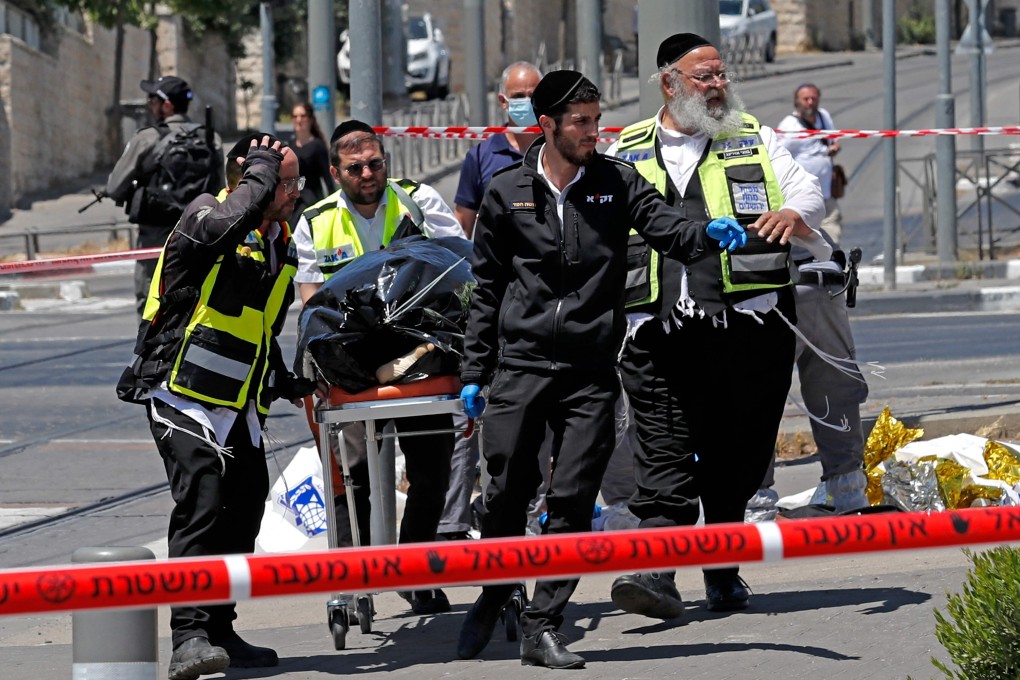 Israeli emergency services transport the body of an assailant, who was shot dead by police after stabbing two Israeli men, in Israeli-annexed east Jerusalem, on Monday. Photo: AFP