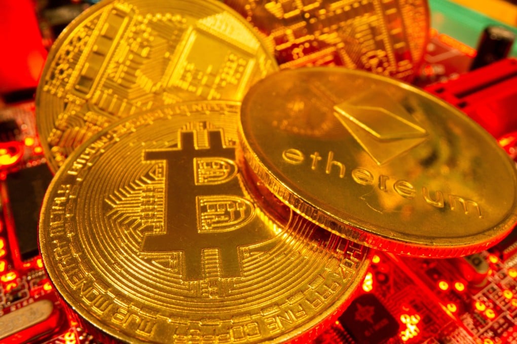 Representations of the virtual currencies bitcoin and Ethereum stand on a motherboard in this picture illustration taken May 20, 2021. Photo: Reuters