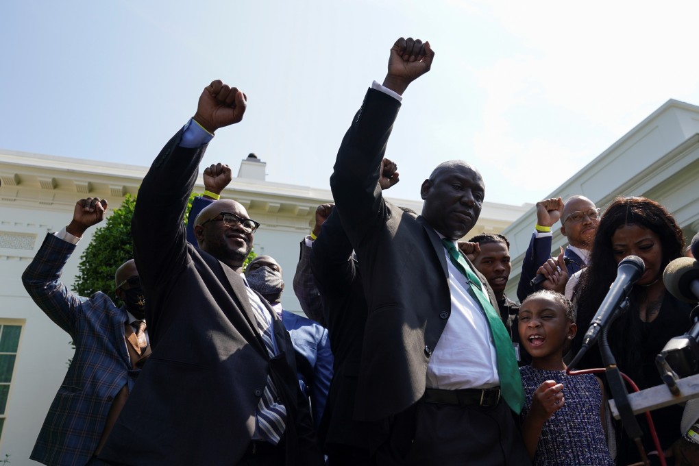 Gianna Floyd, daughter of George Floyd, along with other family members and lawyers, raise fists and say his name while facing reporters at the White House following their meeting with President Joe Biden on Tuesday. Photo: Reuters