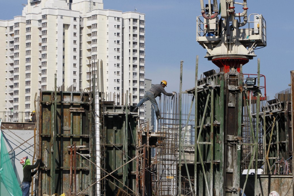 Construction workers build a new condominium tower in a Kuala Lumpur suburb. File photo: AP