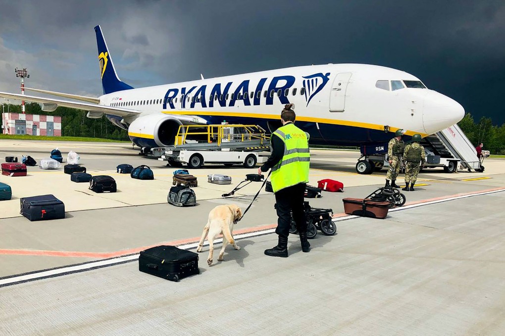 A Belarusian dog handler checks the luggage from a Ryanair flight at Minsk International Airport, in Minsk, Belarus, on May 23. Photo: AFP