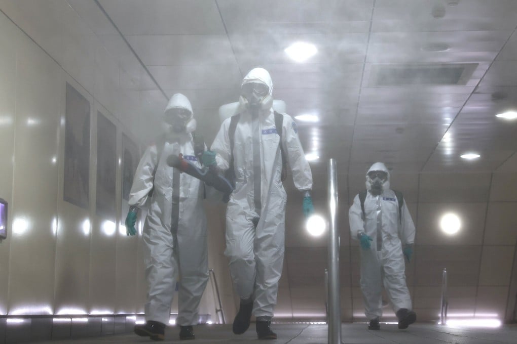 Soldiers in protective suits disinfect a metro station following a surge of Covid-19 infections in Taipei on May 25. After managing the pandemic well, Taiwan has struggled with a rise in cases in the past month. Photo: Reuters