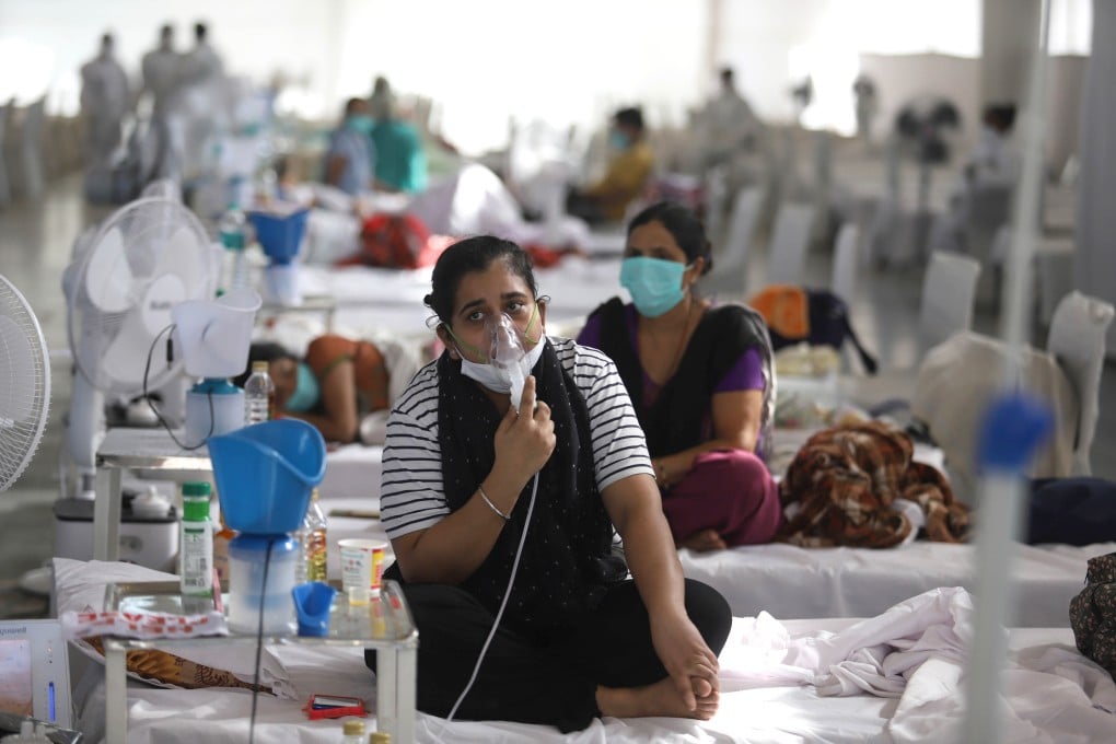 A Covid-19 patient uses an oxygen mask at a temporary care centre in New Delhi. Photo: DPA