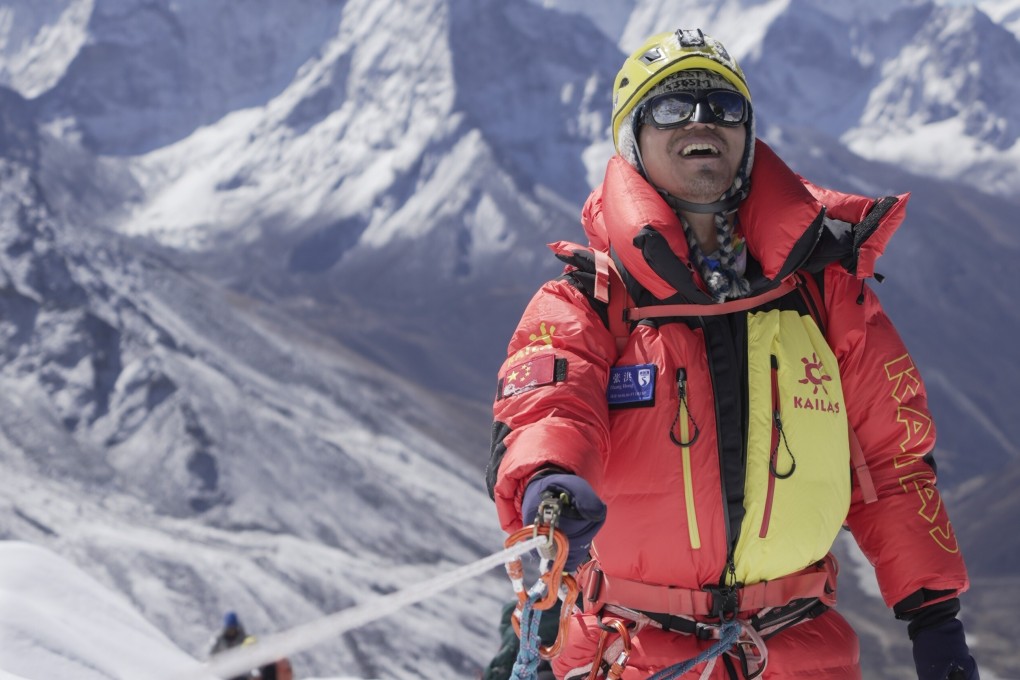 Chinese mountaineer Zhang Hong, the first blind Asian person to scale Mount Everest, smiles after reaching the top of a difficult section of the climb. Photos: InHope Pictures