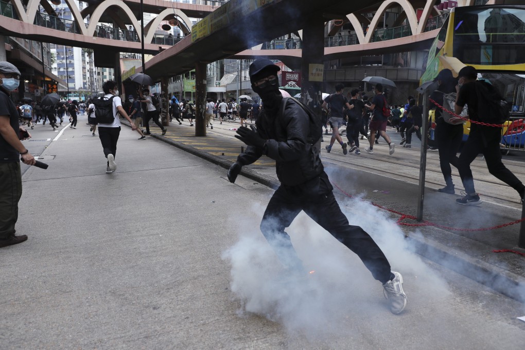 Riot police fire tear gas near Sogo department store in Causeway Bay. Photo: Sam Tsang